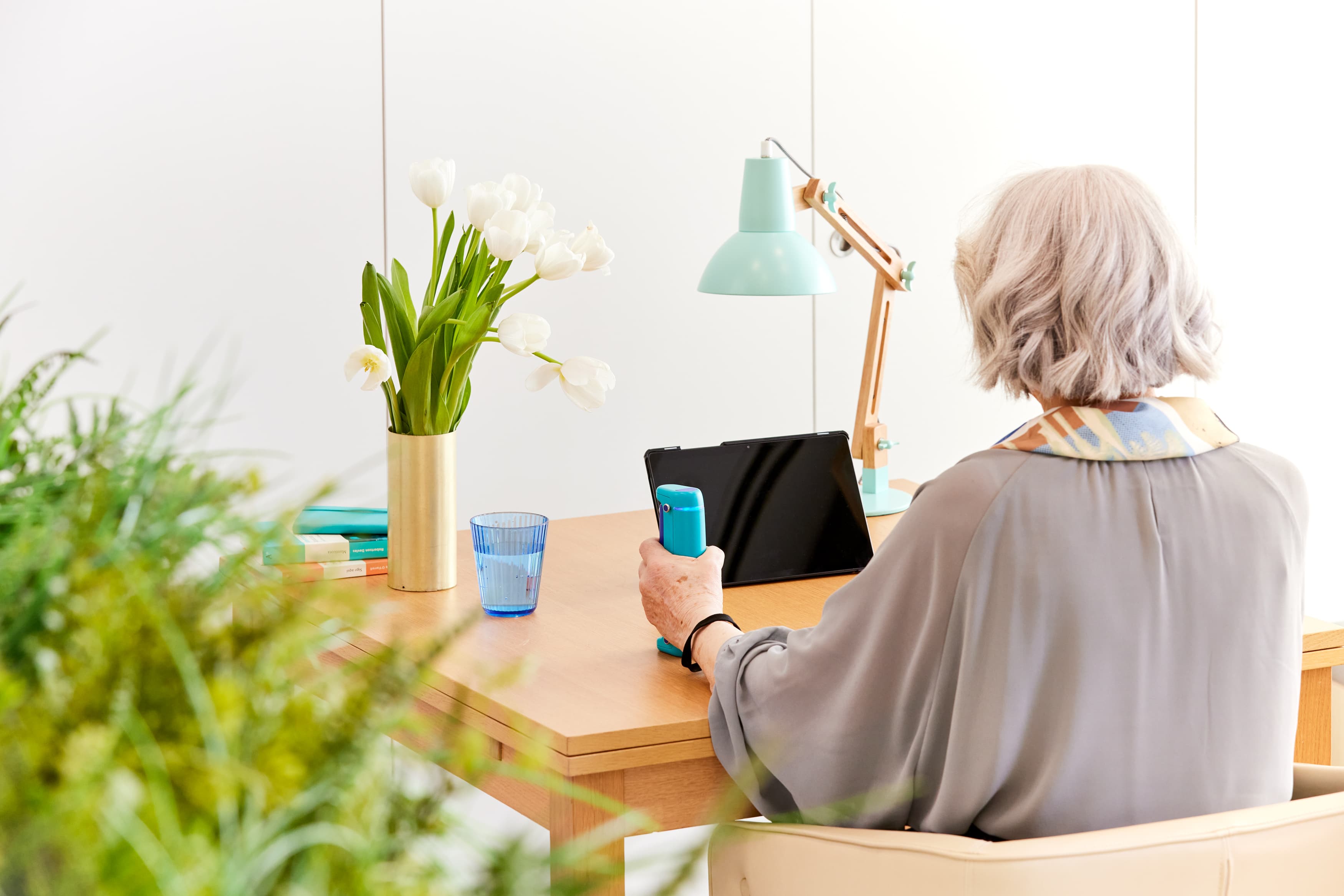 Older woman using the Able Assess sensor at home