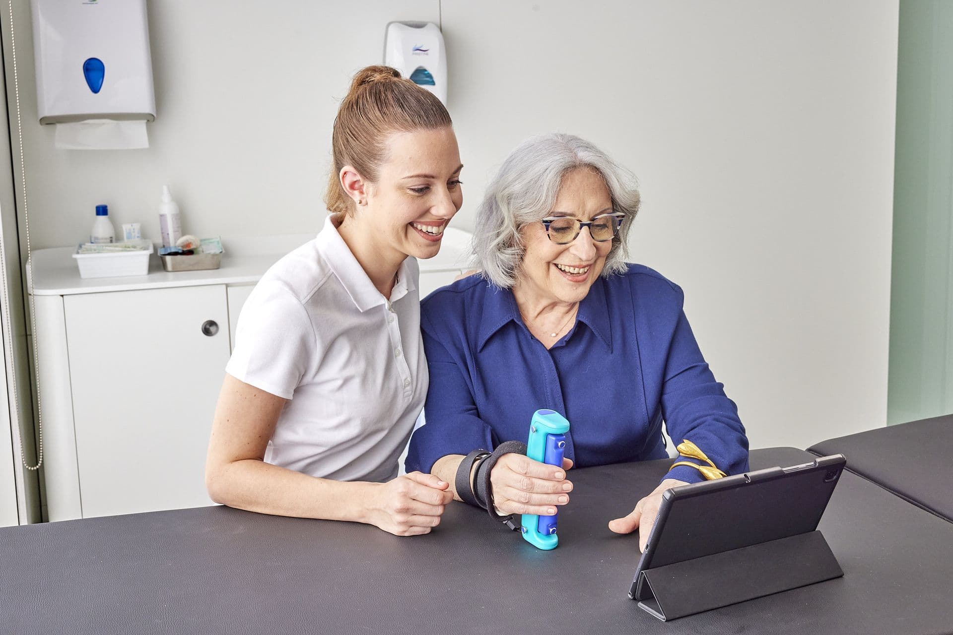 Clinician reviewing Able Assess results with a patient on a tablet in a hospital setting