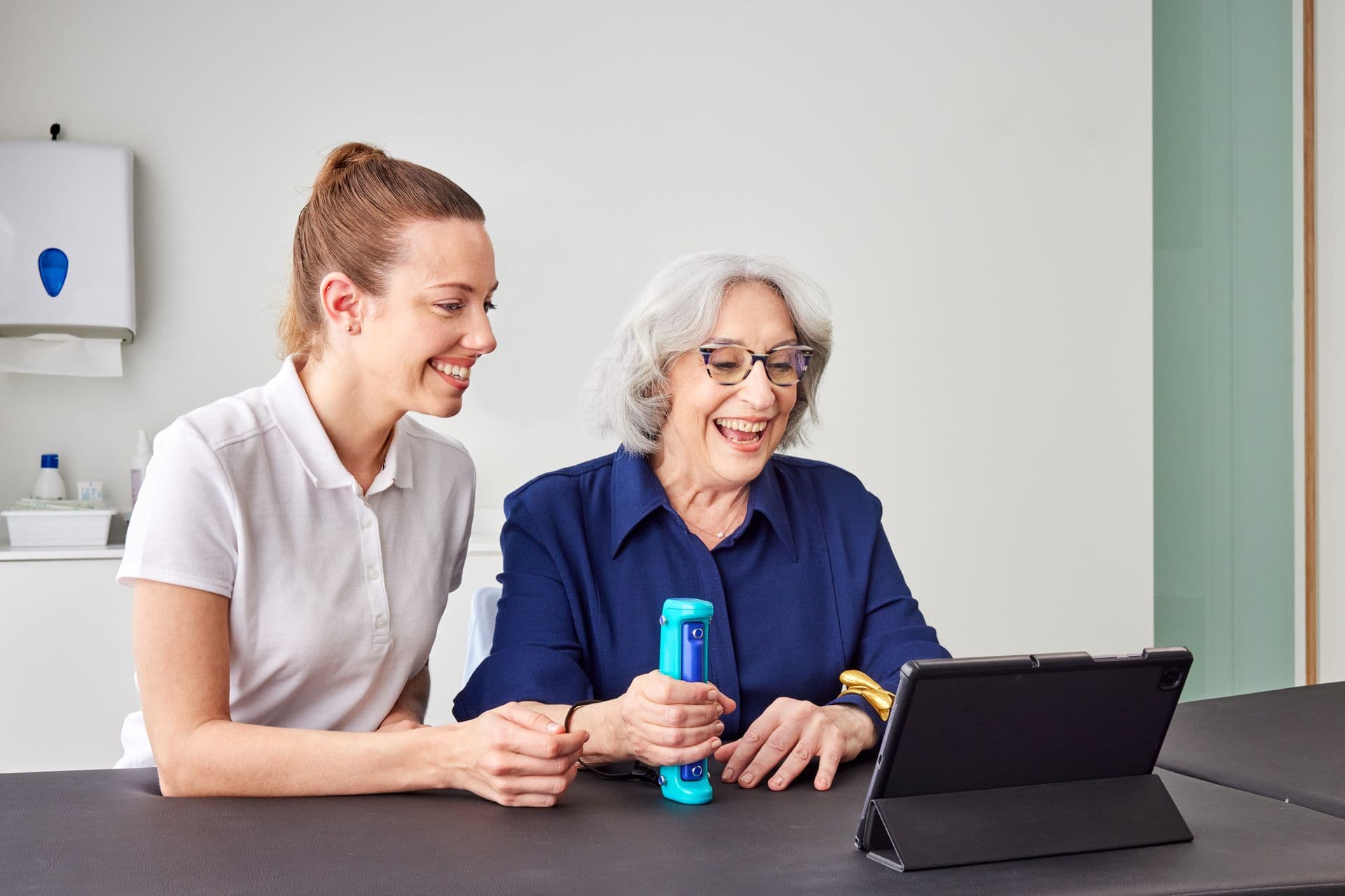 Therapist guiding a patient through a GripAble rehabilitation session