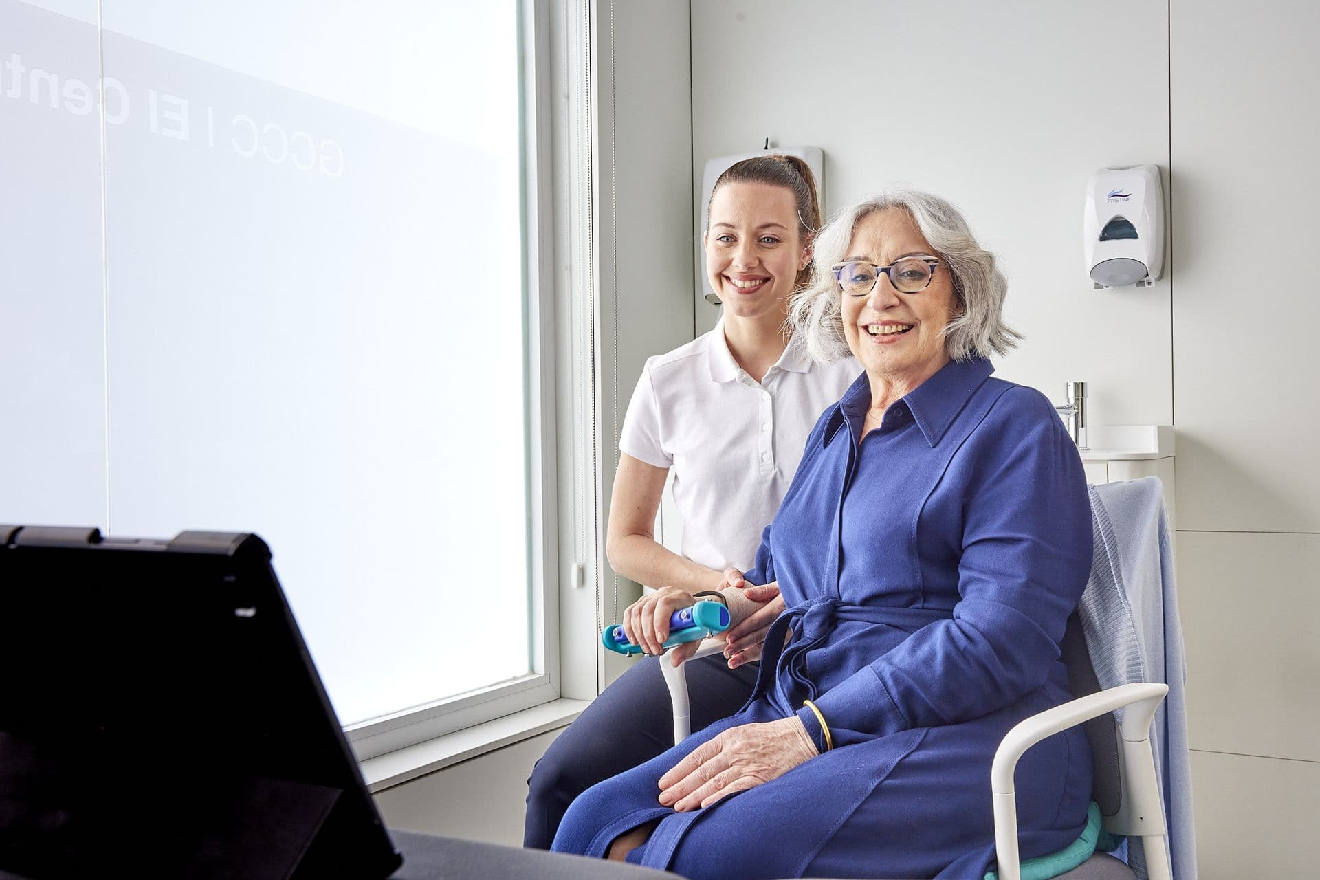 Patient and therapist smiling during a wellness screening session